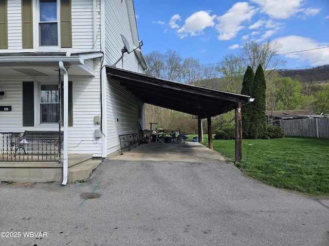 225 Pickwick St, Mill Hall, PA 17751 - view of property exterior with fence, a yard, driveway, covered porch, and a carport