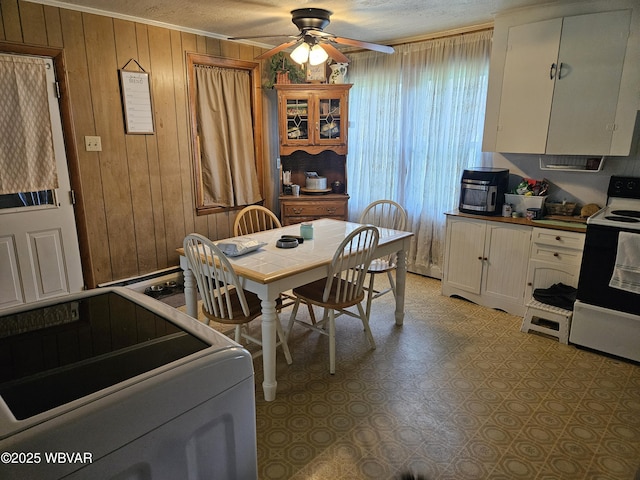 225 Pickwick St, Mill Hall, PA 17751 - dining space with crown molding, wood walls, and ceiling fan