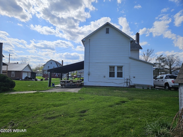 225 Pickwick St, Mill Hall, PA 17751 - rear view of house with a chimney, an attached carport, and a yard