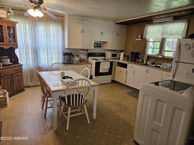225 Pickwick St, Mill Hall, PA 17751 - kitchen with electric range, freestanding refrigerator, white cabinetry, a ceiling fan, and washer / clothes dryer