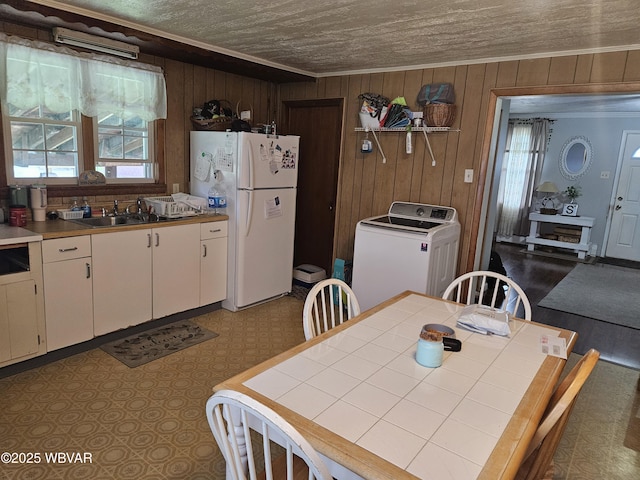 225 Pickwick St, Mill Hall, PA 17751 - dining space featuring washer / dryer, crown molding, and wood walls