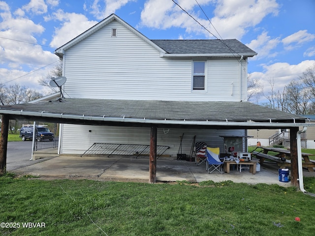 225 Pickwick St, Mill Hall, PA 17751 - rear view of house featuring a patio area, a shingled roof, and a yard