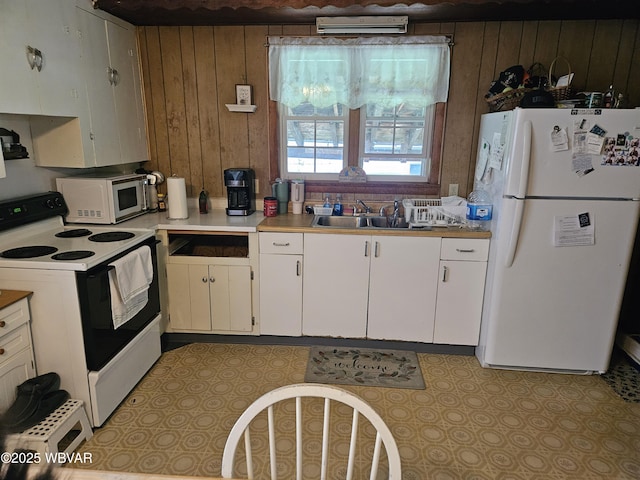 225 Pickwick St, Mill Hall, PA 17751 - kitchen featuring a sink, electric range, freestanding refrigerator, white cabinetry, and wooden walls