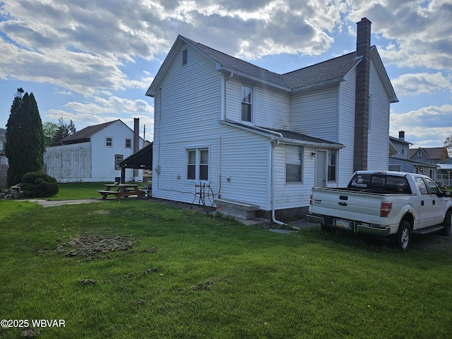 225 Pickwick St, Mill Hall, PA 17751 - back of house featuring a chimney and a yard