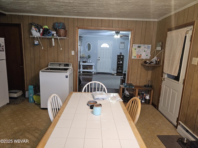 225 Pickwick St, Mill Hall, PA 17751 - dining space featuring ornamental molding, wood walls, washer / clothes dryer, and a ceiling fan