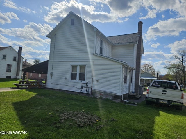 225 Pickwick St, Mill Hall, PA 17751 - back of house with a lawn, a chimney, and entry steps