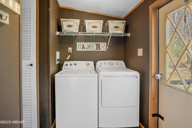laundry room featuring ornamental molding, a textured ceiling, and independent washer and dryer