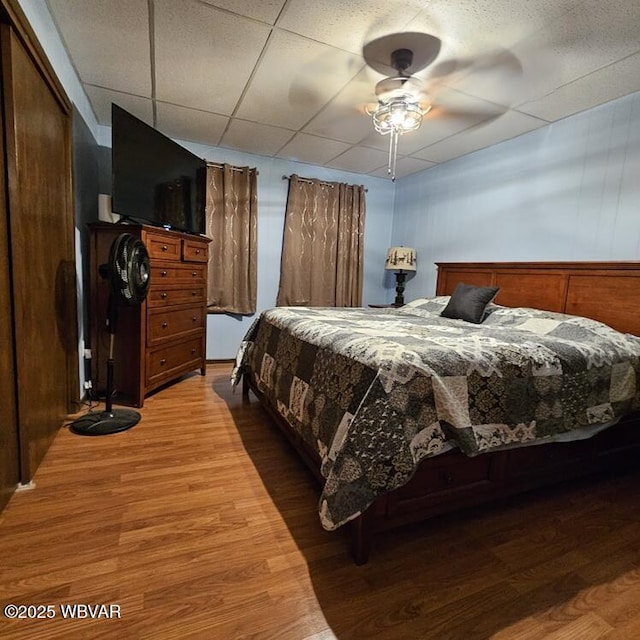 bedroom with a ceiling fan and wood finished floors