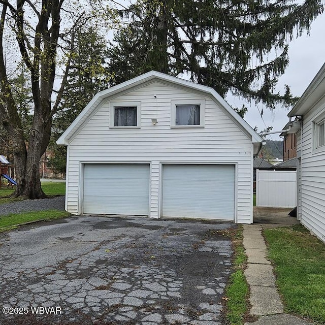 garage featuring a garage and fence