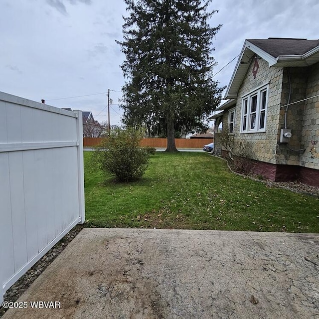 view of yard featuring a patio area and fence