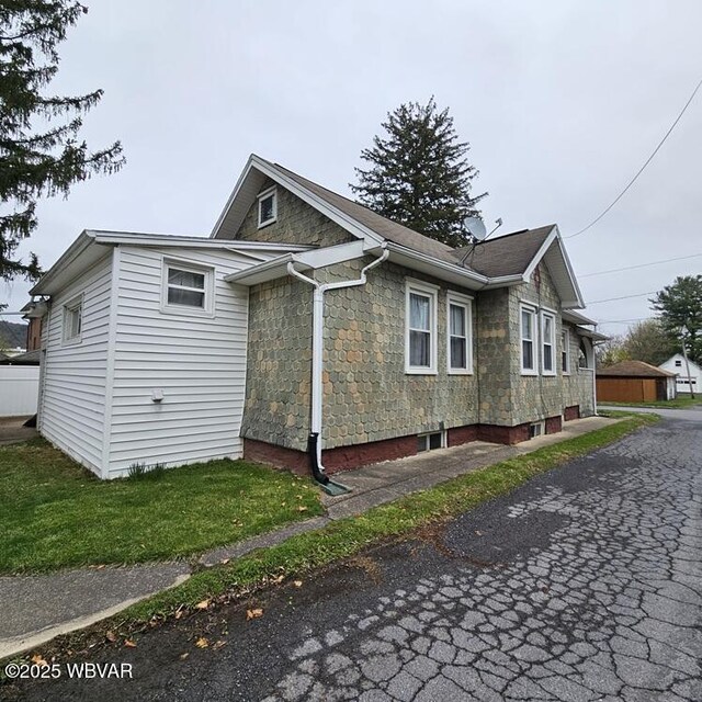 view of side of home featuring stone siding