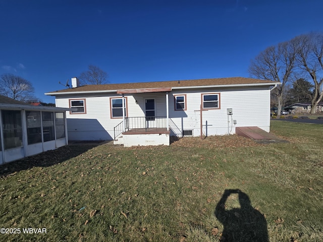 view of front of house featuring a front lawn and a sunroom