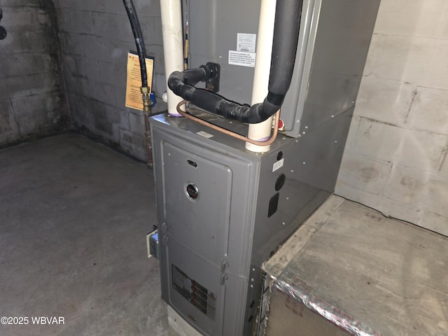 utility room featuring heating unit