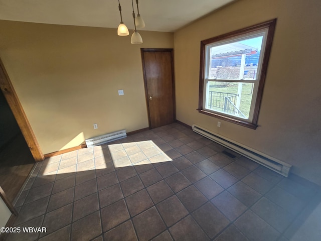 tiled empty room with a baseboard heating unit