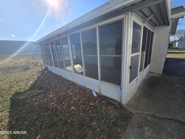 view of home's exterior with a sunroom