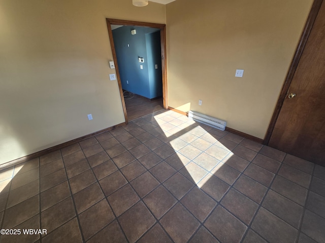 spare room with dark tile patterned floors