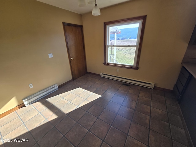 unfurnished living room with dark tile patterned flooring and a baseboard radiator