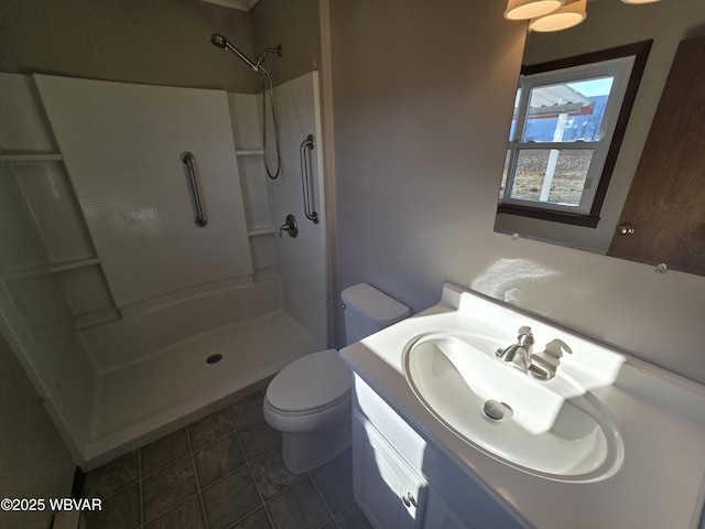 bathroom with a shower, toilet, vanity, and tile patterned flooring