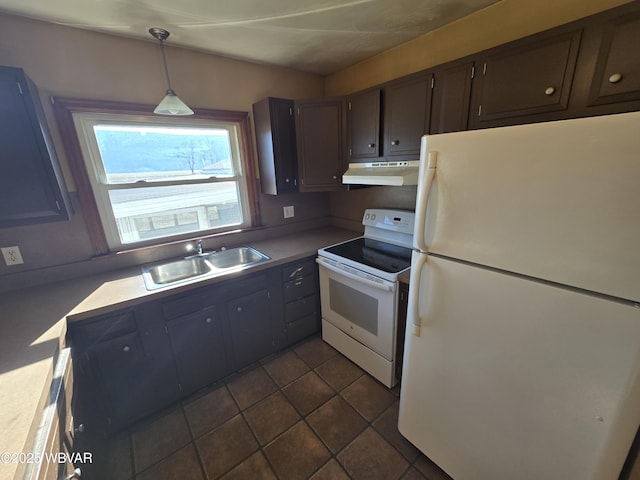 kitchen featuring dark tile patterned flooring, white appliances, sink, hanging light fixtures, and dark brown cabinets