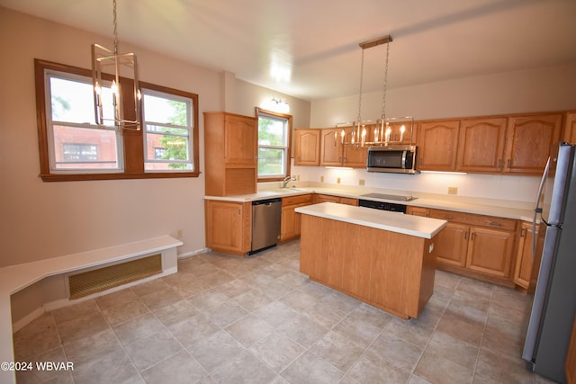 kitchen featuring stainless steel appliances, a kitchen island, hanging light fixtures, and sink