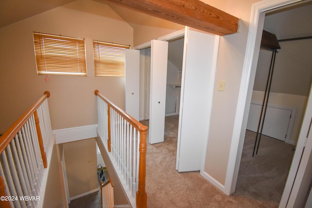 hall featuring vaulted ceiling with beams and light carpet