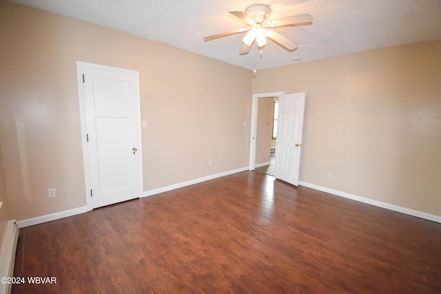 unfurnished room with ceiling fan, a baseboard radiator, dark wood-type flooring, and a textured ceiling