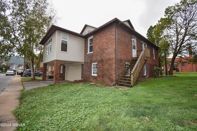 view of home's exterior with a yard and a garage