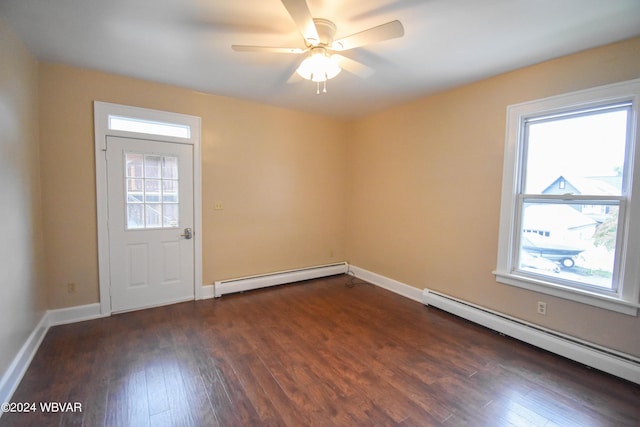 empty room with ceiling fan, dark wood-type flooring, and a baseboard radiator