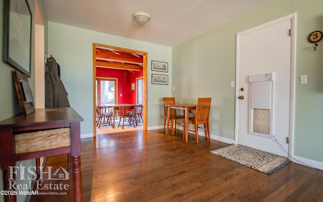 entrance foyer with beam ceiling and hardwood / wood-style floors