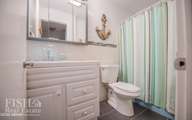 bathroom featuring a shower with curtain, vanity, tile walls, and toilet