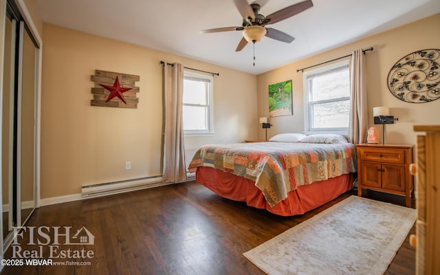 bedroom with multiple windows, a closet, a baseboard radiator, and dark hardwood / wood-style floors