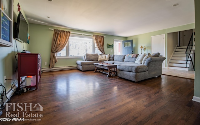 living room with dark hardwood / wood-style floors and a baseboard heating unit