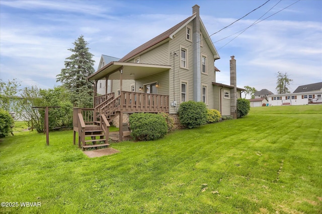 back of property featuring a yard, a deck, stairs, and a chimney