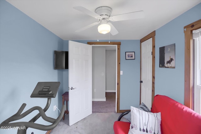 carpeted home office featuring a ceiling fan and baseboards