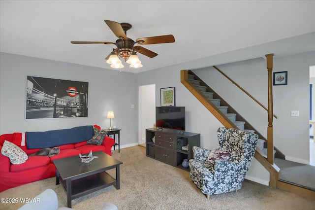 living room with stairs, carpet flooring, a ceiling fan, and baseboards