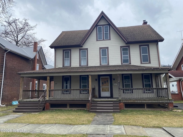 view of front facade featuring a front lawn, a chimney, a porch, and roof with shingles