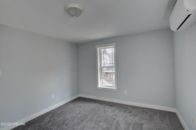 empty room with dark colored carpet, an AC wall unit, and baseboards