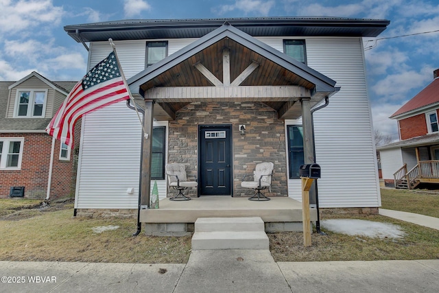 view of front of home featuring stone siding and a porch