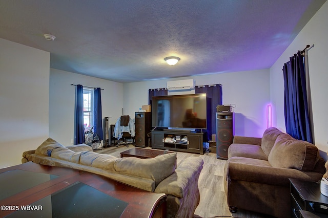 living area with a textured ceiling and wood finished floors