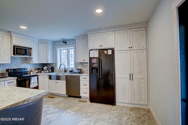 kitchen featuring a sink, baseboards, light countertops, black appliances, and tasteful backsplash