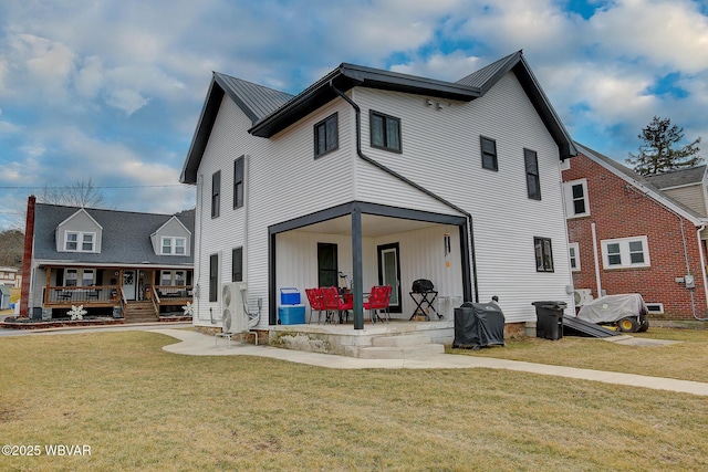 rear view of property featuring a patio area and a lawn