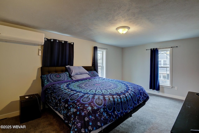 bedroom with a textured ceiling, dark carpet, multiple windows, and a wall unit AC