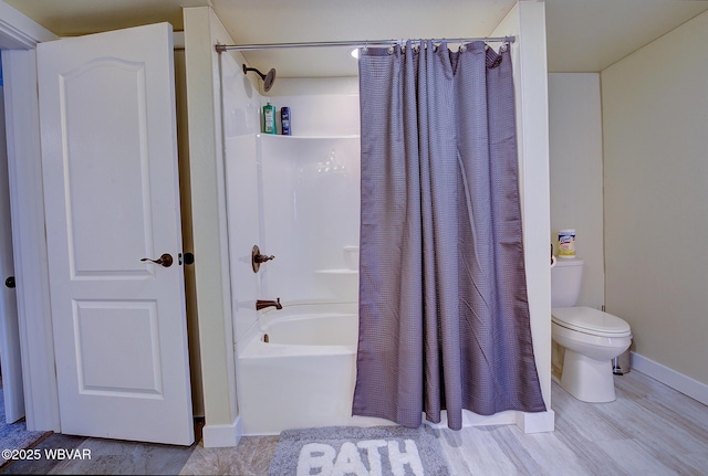 full bath with toilet, shower / tub combo, baseboards, and wood finished floors