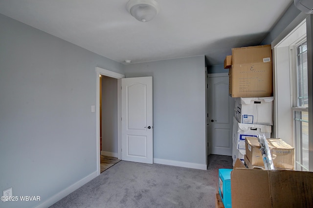 interior space featuring carpet floors and baseboards