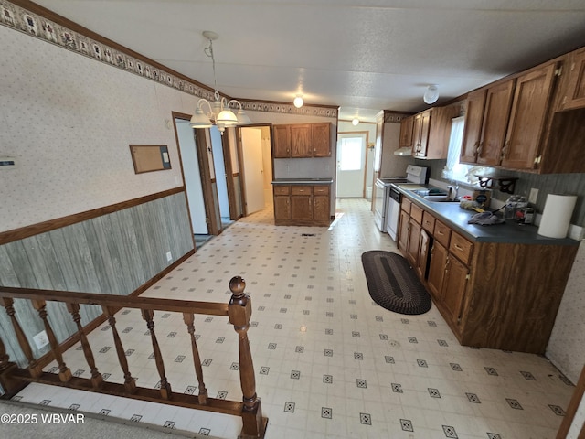 kitchen with sink, white electric range oven, decorative light fixtures, and ornamental molding