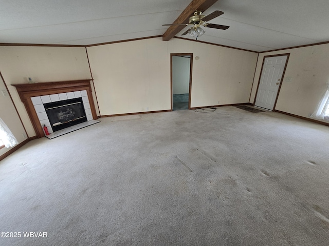 unfurnished living room with ceiling fan, light colored carpet, a fireplace, and lofted ceiling with beams