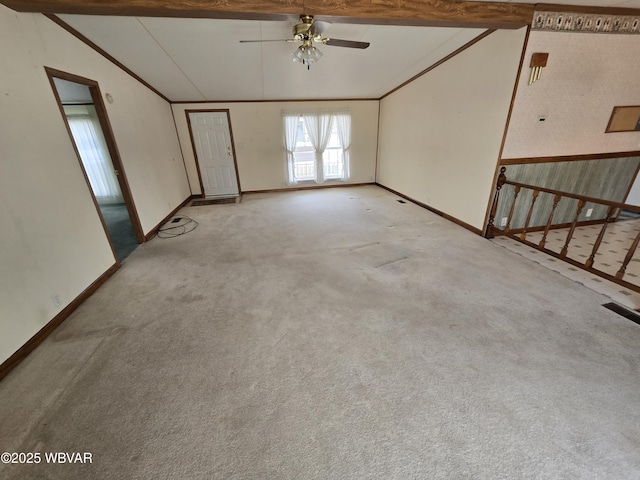 carpeted spare room with ceiling fan and lofted ceiling with beams