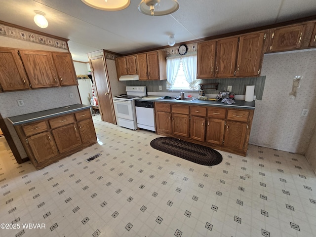 kitchen featuring sink and white appliances