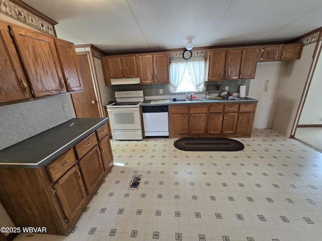 kitchen featuring sink and white appliances