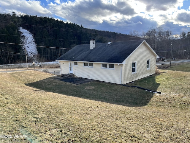 rear view of property featuring a yard